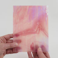 Video of the Rosebud glass plate in iridescent translucent pink, 15x19cm, held up and tilted to show its pattern and transparency