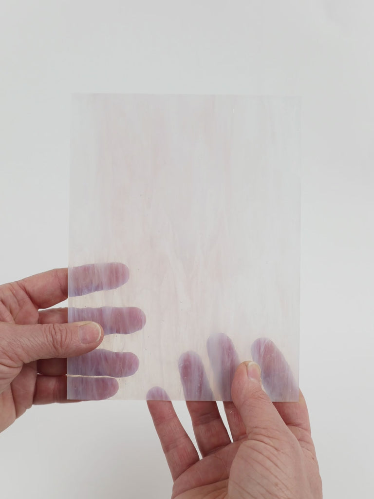 Video of the Barely Blush glass plate in transparent pink, 15x19cm, held up and tilted to show its pattern and transparency