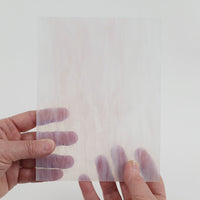 Video of the Barely Blush glass plate in transparent pink, 15x19cm, held up and tilted to show its pattern and transparency