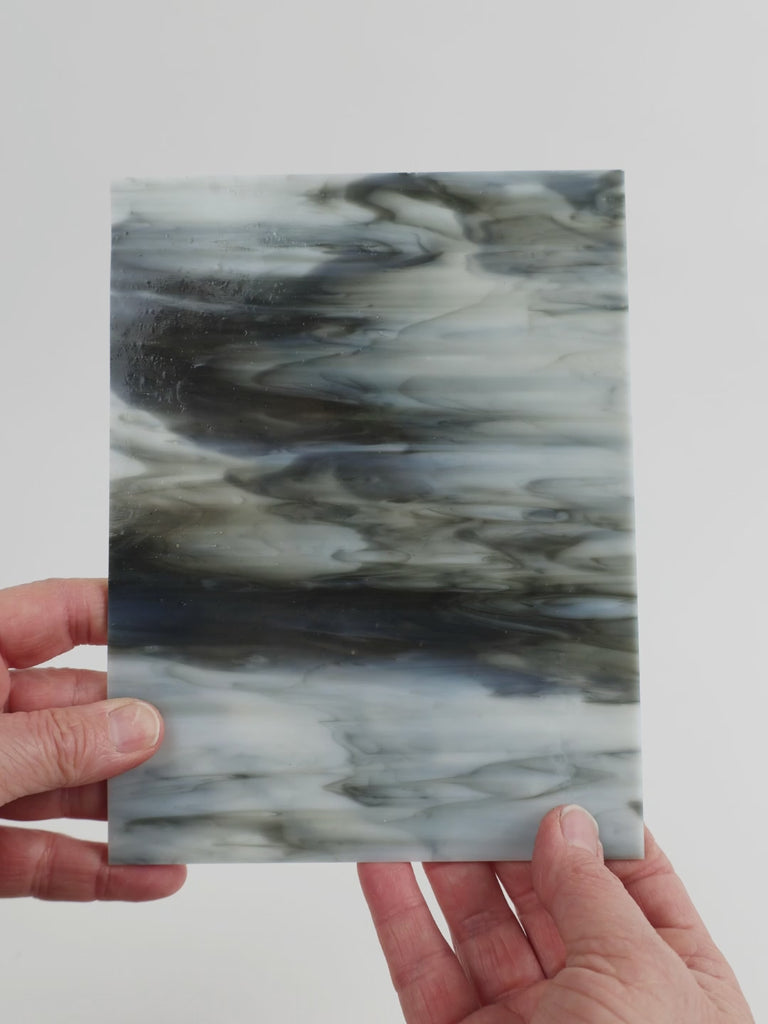 Video of the opal grey glass plate in grey translucent, 15x19cm, held up and tilted to show its pattern and transparency