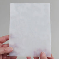 Video of the cloud glass plate in white semi-transparant, 15x19cm, held up and tilted to show its pattern and transparency